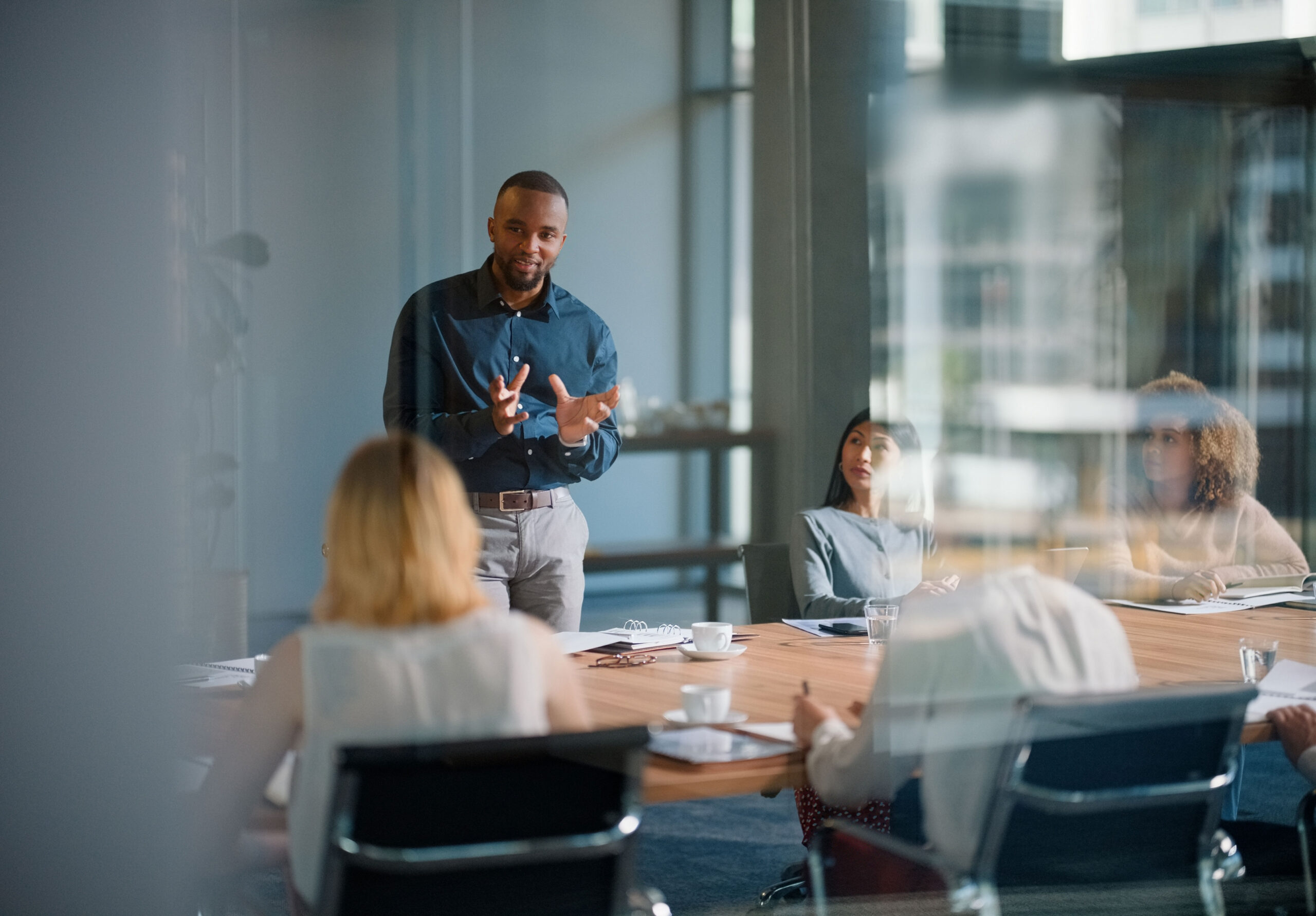 Business professionals meeting in a boardroom, collaborating on strategy and team planning during a presentation or workshop