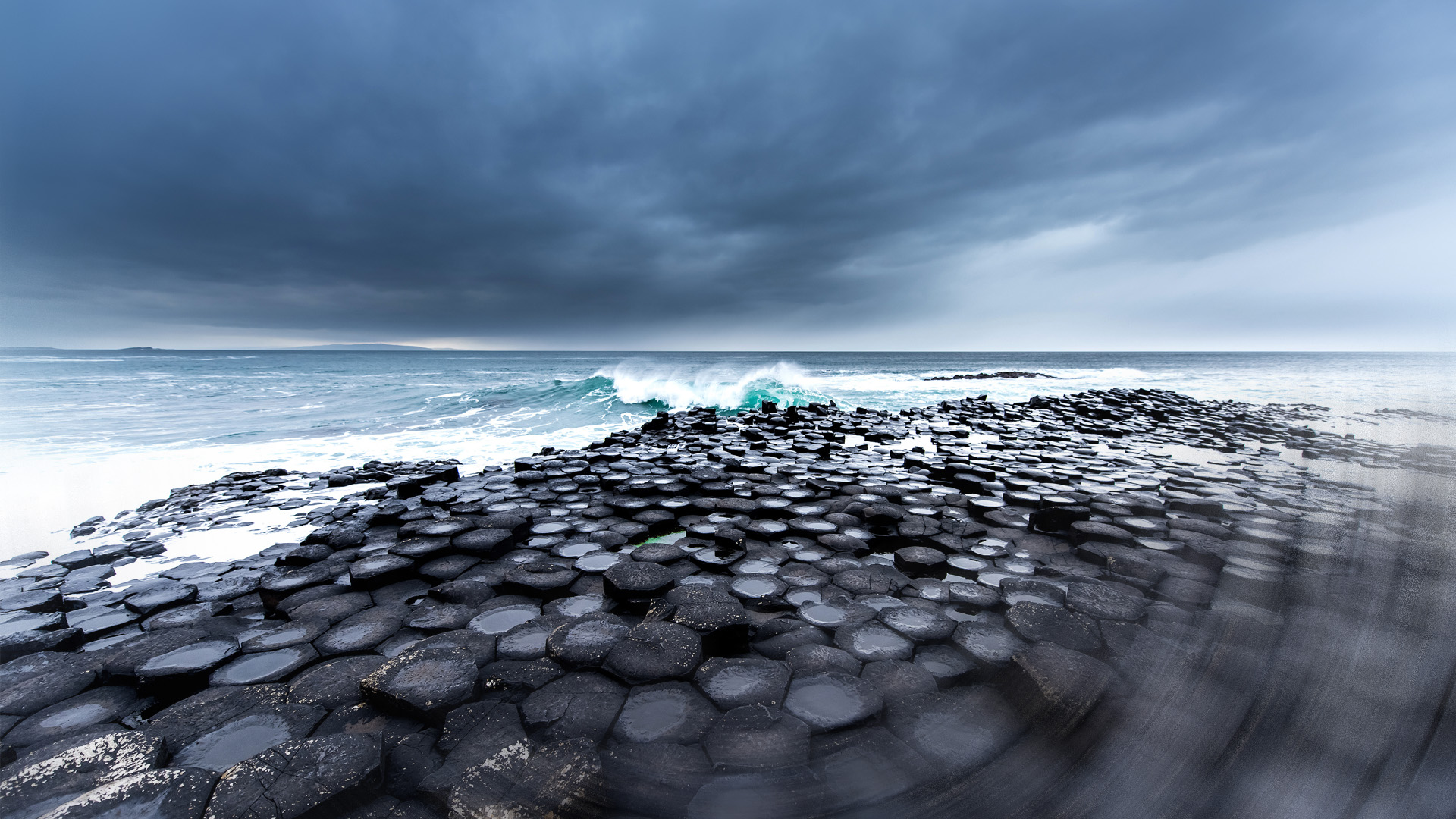 Rock formation with crashing ocean waves