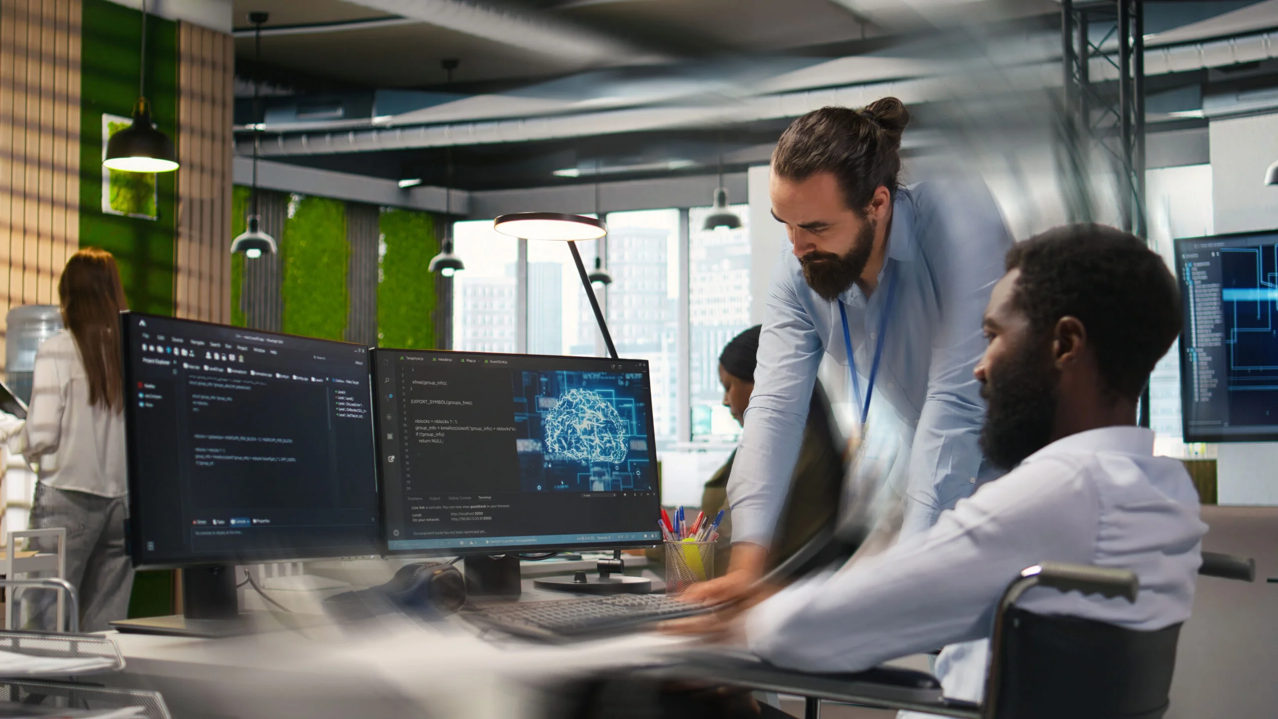 Man in wheelchair and coworker in office transforming data into AI predictive models